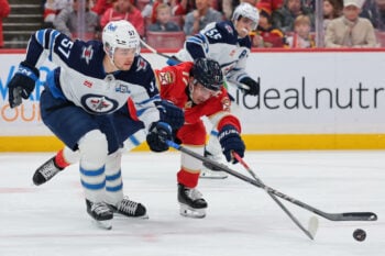 Jan 31, 2026; Sunrise, Florida, USA; Florida Panthers center Evan Rodrigues (17) and Winnipeg Jets defenseman Elias Salomonsson (57) battle for the puck during the second period at Amerant Bank Arena. Mandatory Credit: Sam Navarro-Imagn Images