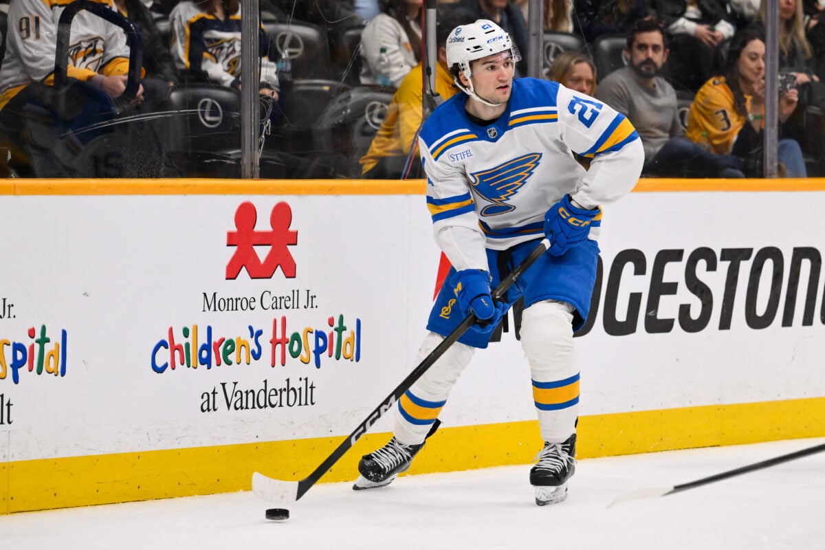 Feb 2, 2026; Nashville, Tennessee, USA;  St. Louis Blues right wing Jimmy Snuggerud (21) against the Nashville Predators during the third period at Bridgestone Arena. Mandatory Credit: Steve Roberts-Imagn Images