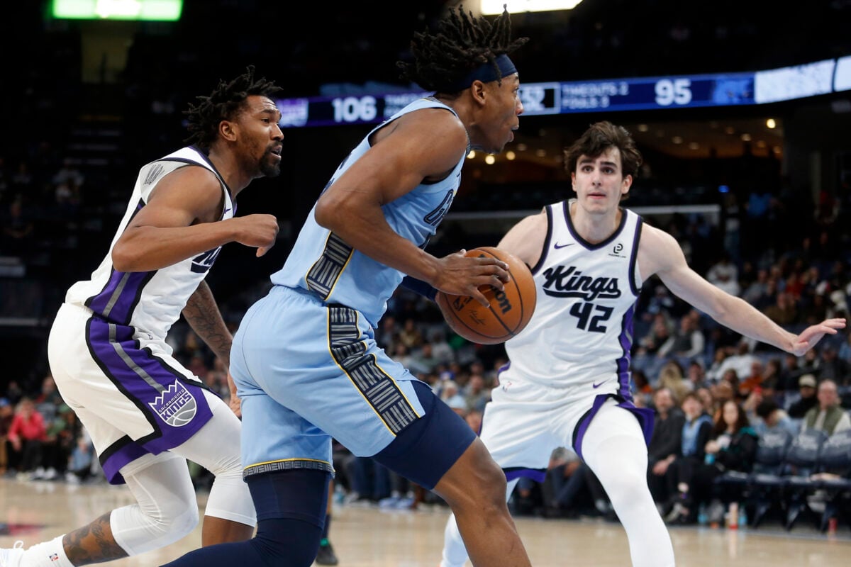 Feb 23, 2026; Memphis, Tennessee, USA; Memphis Grizzlies forward GG Jackson (45) drives to the basket as Sacramento Kings guard Malik Monk (0) and Sacramento Kings center Maxime Raynaud (42) defends during the fourth quarter at FedExForum. Mandatory Credit: Petre Thomas-Imagn Images