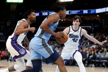 Feb 23, 2026; Memphis, Tennessee, USA; Memphis Grizzlies forward GG Jackson (45) drives to the basket as Sacramento Kings guard Malik Monk (0) and Sacramento Kings center Maxime Raynaud (42) defends during the fourth quarter at FedExForum. Mandatory Credit: Petre Thomas-Imagn Images