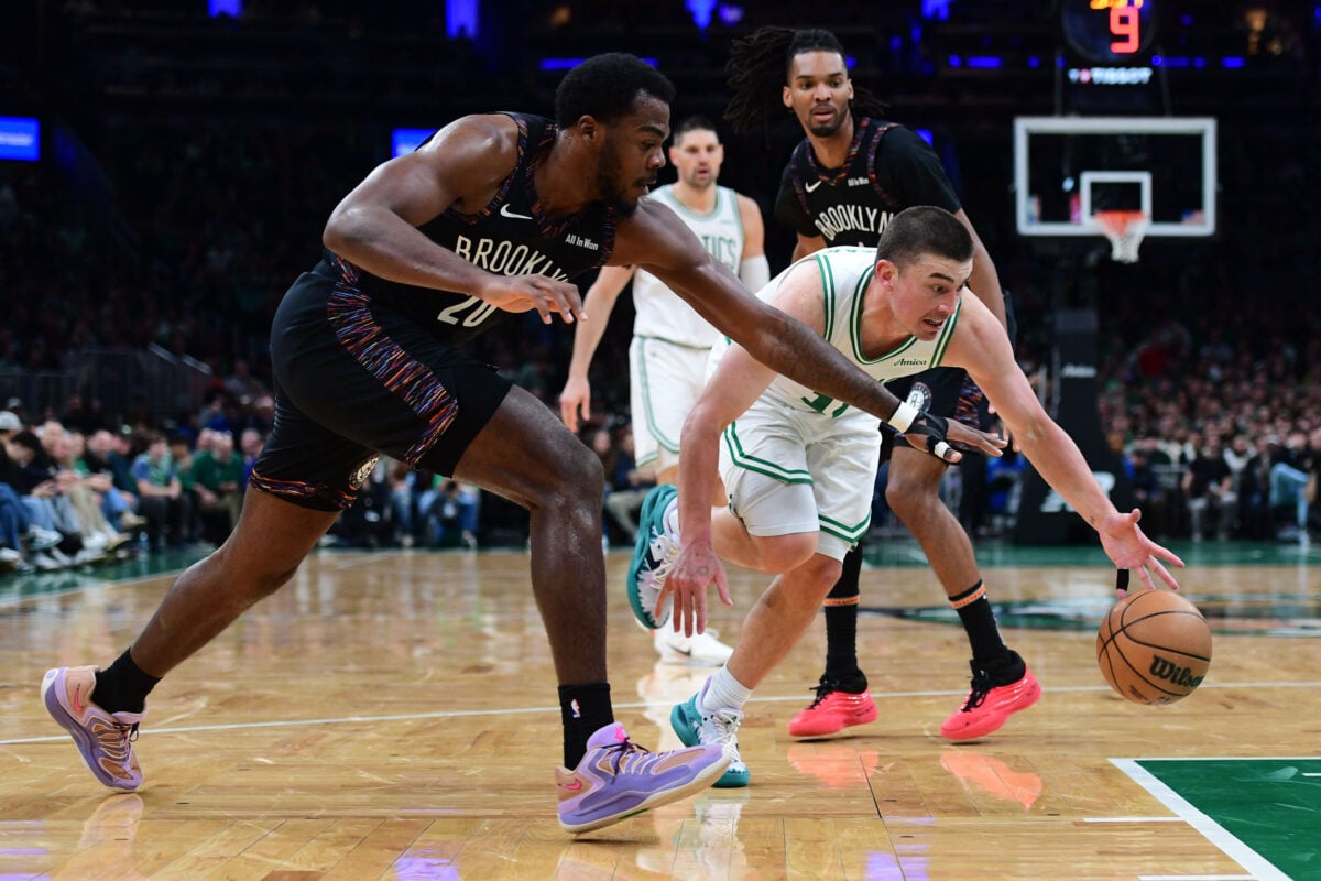Feb 27, 2026; Boston, Massachusetts, USA; Boston Celtics guard Payton Pritchard (11) dribbles the ball past Brooklyn Nets center Day'ron Sharpe (20) during the second half at TD Garden. Mandatory Credit: Bob DeChiara-Imagn Images