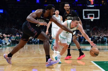 Feb 27, 2026; Boston, Massachusetts, USA; Boston Celtics guard Payton Pritchard (11) dribbles the ball past Brooklyn Nets center Day'ron Sharpe (20) during the second half at TD Garden. Mandatory Credit: Bob DeChiara-Imagn Images