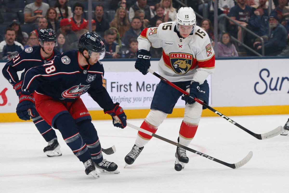 Mar 5, 2026; Columbus, Ohio, USA; Florida Panthers center Anton Lundell (15) chips the puck past Columbus Blue Jackets defenseman Damon Severson (78) during the first period at Nationwide Arena. Mandatory Credit: Russell LaBounty-Imagn Images