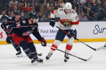 Mar 5, 2026; Columbus, Ohio, USA; Florida Panthers center Anton Lundell (15) chips the puck past Columbus Blue Jackets defenseman Damon Severson (78) during the first period at Nationwide Arena. Mandatory Credit: Russell LaBounty-Imagn Images
