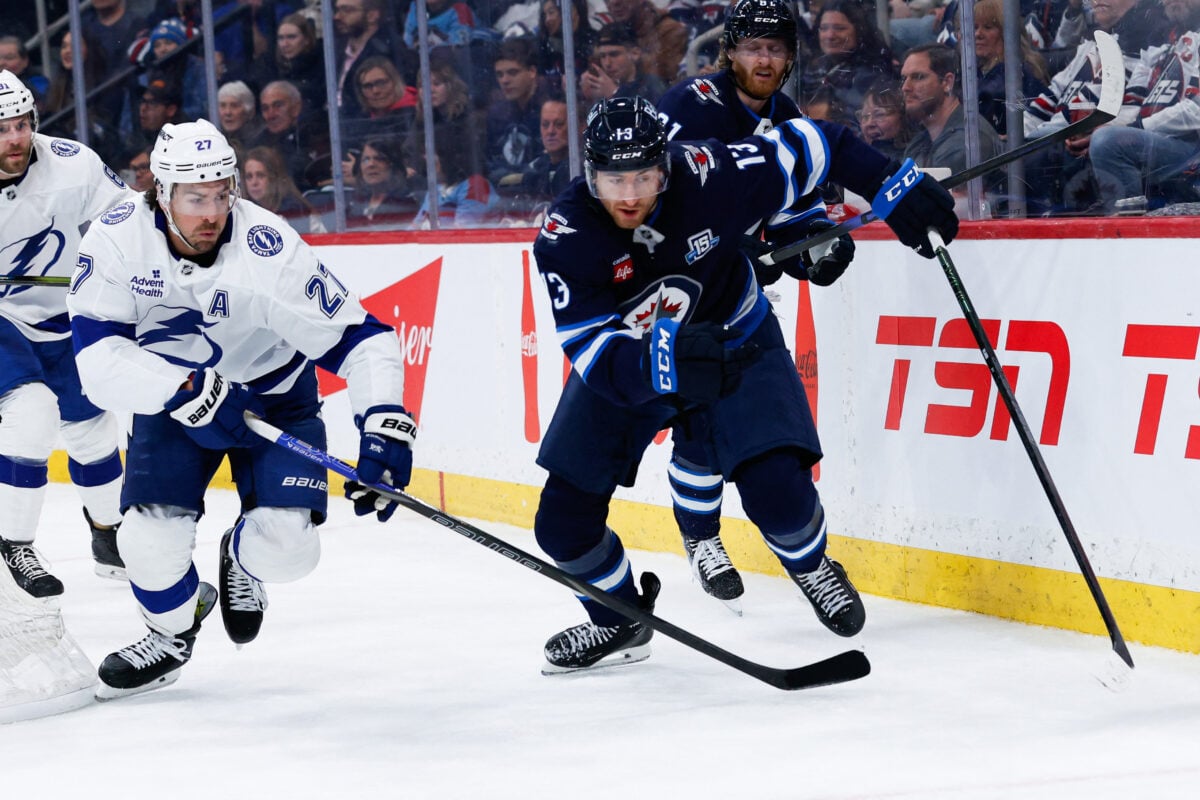 Mar 5, 2026; Winnipeg, Manitoba, CAN;  Tampa Bay Lightning defenseman Ryan McDonagh (27) and Winnipeg Jets forward Gabriel Vilardi (13) skate after the puck during the second period at Canada Life Centre. Mandatory Credit: Terrence Lee-Imagn Images