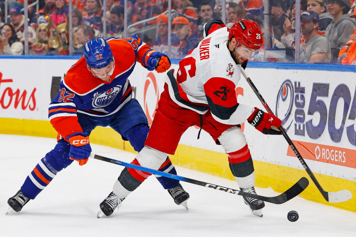 Mar 6, 2026; Edmonton, Alberta, CAN; Carolina Hurricanes defensemen Sean Walker (26) looks to make a pass in front of Edmonton Oilers forward Vasily Podkolzin (92) during the third period at Rogers Place. Mandatory Credit: Perry Nelson-Imagn Images