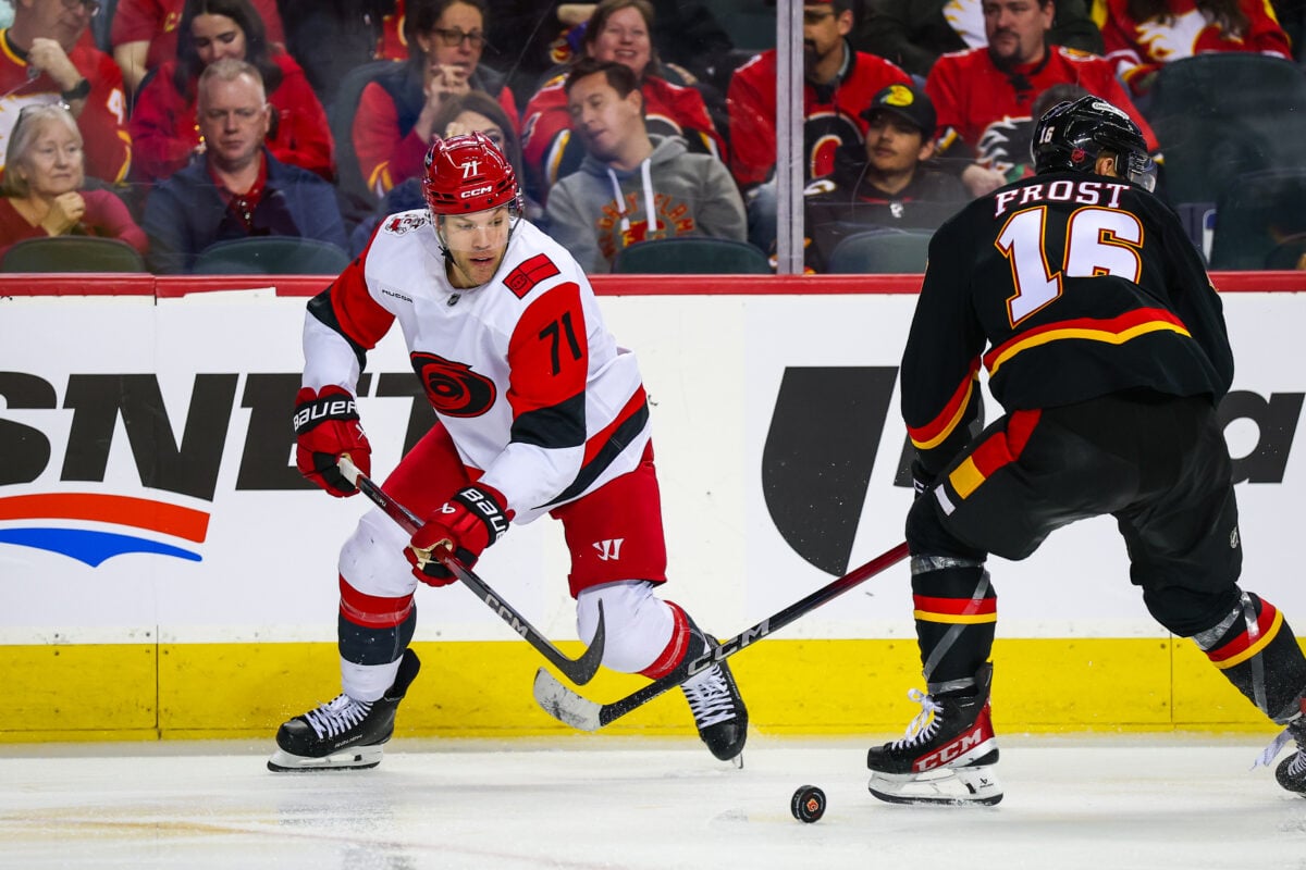 Mar 7, 2026; Calgary, Alberta, CAN; Carolina Hurricanes left wing Taylor Hall (71) controls the puck against Calgary Flames center Morgan Frost (16) during the third period at Scotiabank Saddledome. Mandatory Credit: Sergei Belski-Imagn Images