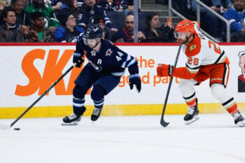 Mar 10, 2026; Winnipeg, Manitoba, CAN;  Winnipeg Jets defenseman Josh Morrissey (44) skates away from Anaheim Ducks forward Jeffrey Viel (28) during the third period at Canada Life Centre. Mandatory Credit: Terrence Lee-Imagn Images