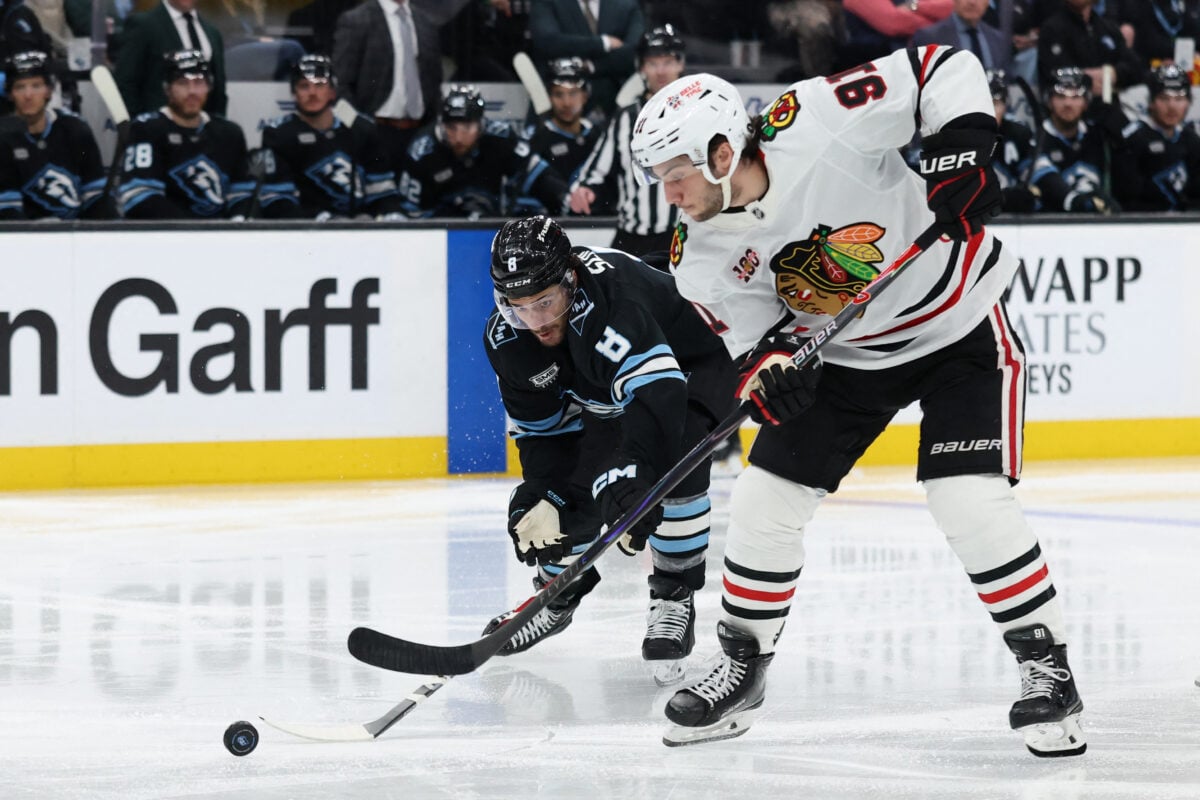 Mar 12, 2026; Salt Lake City, Utah, USA; Utah Mammoth center Nick Schmaltz (8) and Chicago Blackhawks center Frank Nazar (91) battle for the puck during the third period at Delta Center. Mandatory Credit: Rob Gray-Imagn Images