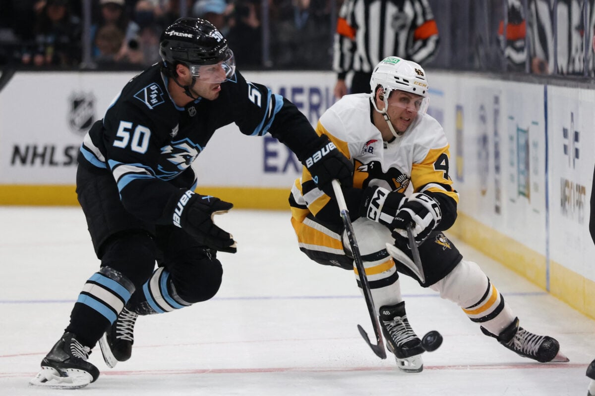 Mar 14, 2026; Salt Lake City, Utah, USA; Utah Mammoth defenseman Sean Durzi (50) and Pittsburgh Penguins center Blake Lizotte (46) battle for the puck during the third period at Delta Center. Mandatory Credit: Rob Gray-Imagn Images