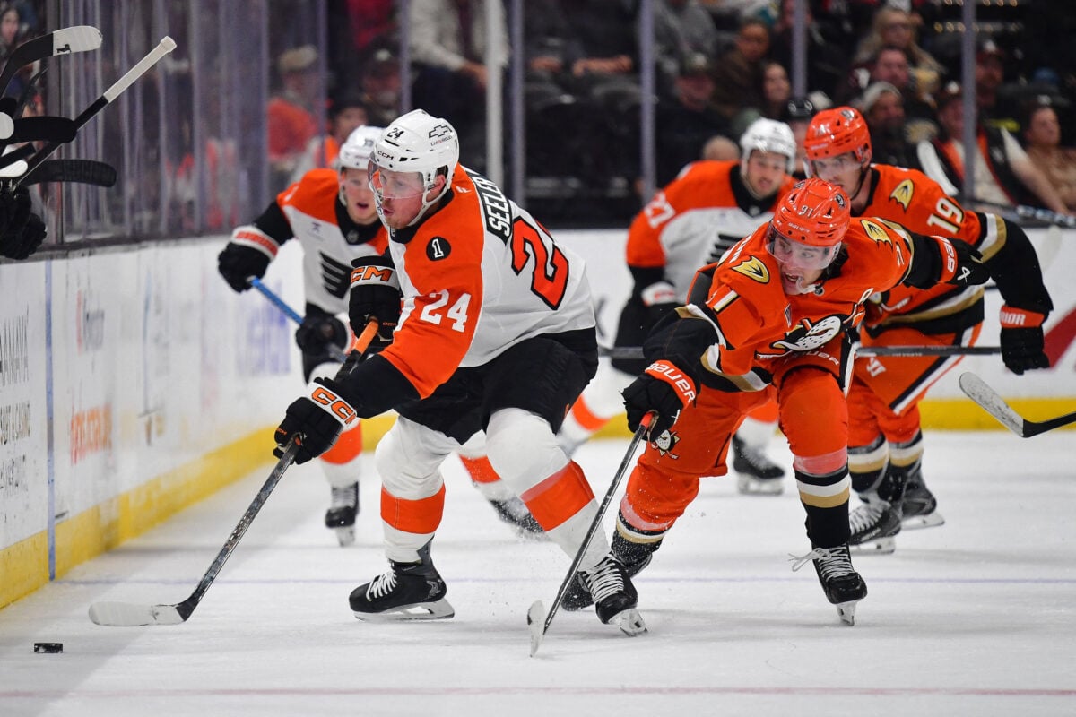 Mar 18, 2026; Anaheim, California, USA; Anaheim Ducks center Leo Carlsson (91) plays for the puck against Philadelphia Flyers defenseman Nick Seeler (24) during the second period at Honda Center. Mandatory Credit: Gary A. Vasquez-Imagn Images