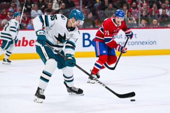 Mar 14, 2026; Montreal, Quebec, CAN; San Jose Sharks defenseman Shakir Mukhamadullin (85) plays the puck against Montreal Canadiens center Jake Evans (71) during the second period at Bell Centre. Mandatory Credit: David Kirouac-Imagn Images