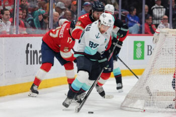 Mar 24, 2026; Sunrise, Florida, USA; Seattle Kraken center Frederick Gaudreau (89) moves the puck against Florida Panthers defenseman Aaron Ekblad (5) during the second period at Amerant Bank Arena. Mandatory Credit: Sam Navarro-Imagn Images