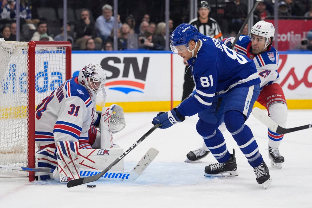 Mar 25, 2026; Toronto, Ontario, CAN; Toronto Maple Leafs forward Dakota Joshua (81) tries to get control of the puck against New York Rangers goaltender Igor Shesterkin (31) as New York Rangers defenseman Matthew Robertson (29) closes in during the third period at Scotiabank Arena. Mandatory Credit: John E. Sokolowski-Imagn Images