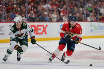 Mar 26, 2026; Sunrise, Florida, USA; Florida Panthers center Sam Bennett (9) moves the puck against Minnesota Wild defenseman Brock Faber (7) during the second period at Amerant Bank Arena. Mandatory Credit: Sam Navarro-Imagn Images