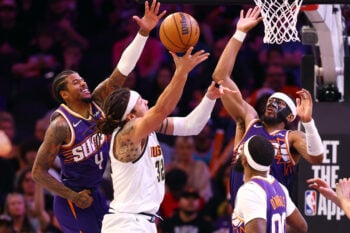 Mar 24, 2026; Phoenix, Arizona, USA; Denver Nuggets forward Aaron Gordon (32) drives to the basket against Phoenix Suns guard Jalen Green (4) and Jordan Goodwin (23) at Mortgage Matchup Center. Mandatory Credit: Mark J. Rebilas-Imagn Images