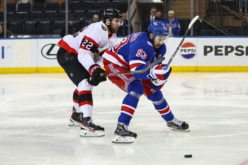 Mar 23, 2026; New York, New York, USA;  Ottawa Senators right wing Michael Amadio (22) and New York Rangers center Mika Zibanejad (93) at Madison Square Garden. Mandatory Credit: Wendell Cruz-Imagn Images