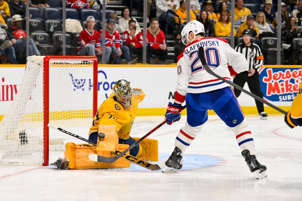 Mar 28, 2026; Nashville, Tennessee, USA;  Nashville Predators goaltender Juuse Saros (74) blocks the shot of Montreal Canadiens left wing Juraj Slafkovský (20) during the second period at Bridgestone Arena. Mandatory Credit: Steve Roberts-Imagn Images