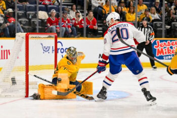 Mar 28, 2026; Nashville, Tennessee, USA;  Nashville Predators goaltender Juuse Saros (74) blocks the shot of Montreal Canadiens left wing Juraj Slafkovský (20) during the second period at Bridgestone Arena. Mandatory Credit: Steve Roberts-Imagn Images