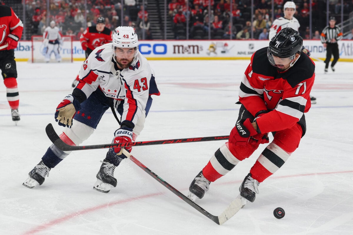 Apr 2, 2026; Newark, New Jersey, USA; Washington Capitals right wing Tom Wilson (43) and New Jersey Devils defenseman Jonas Siegenthaler (71) battle for the puck during the third period at Prudential Center. Mandatory Credit: Ed Mulholland-Imagn Images