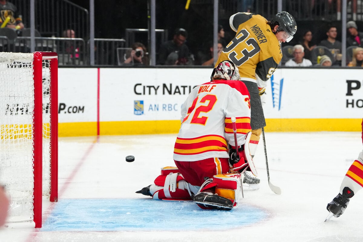 Apr 2, 2026; Las Vegas, Nevada, USA; Vegas Golden Knights right wing Mitch Marner (93) deflects the puck past Calgary Flames goaltender Dustin Wolf (32) to score a goal during the second period at T-Mobile Arena. Mandatory Credit: Stephen R. Sylvanie-Imagn Images
