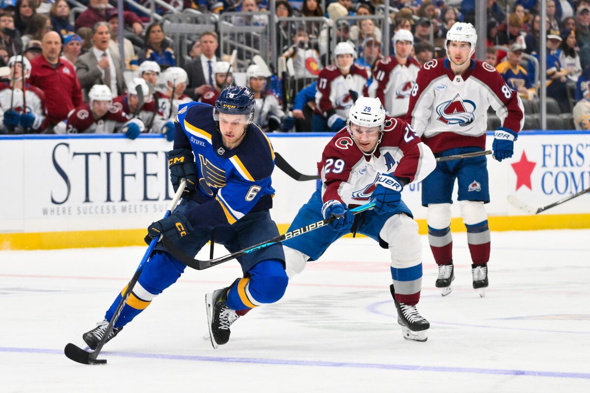 Apr 7, 2026; St. Louis, Missouri, USA; St. Louis Blues defenseman Philip Broberg (6) controls the puck as Colorado Avalanche center Nathan MacKinnon (29) defends during the second period at Enterprise Center. Mandatory Credit: Jeff Curry-Imagn Images