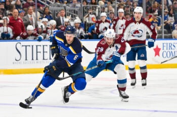 Apr 7, 2026; St. Louis, Missouri, USA; St. Louis Blues defenseman Philip Broberg (6) controls the puck as Colorado Avalanche center Nathan MacKinnon (29) defends during the second period at Enterprise Center. Mandatory Credit: Jeff Curry-Imagn Images