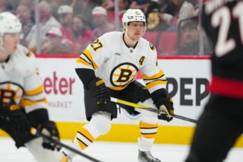 Apr 7, 2026; Raleigh, North Carolina, USA;  Boston Bruins defenseman Hampus Lindholm (27) watches the play against the Carolina Hurricanes during the second period at Lenovo Center. Mandatory Credit: James Guillory-Imagn Images