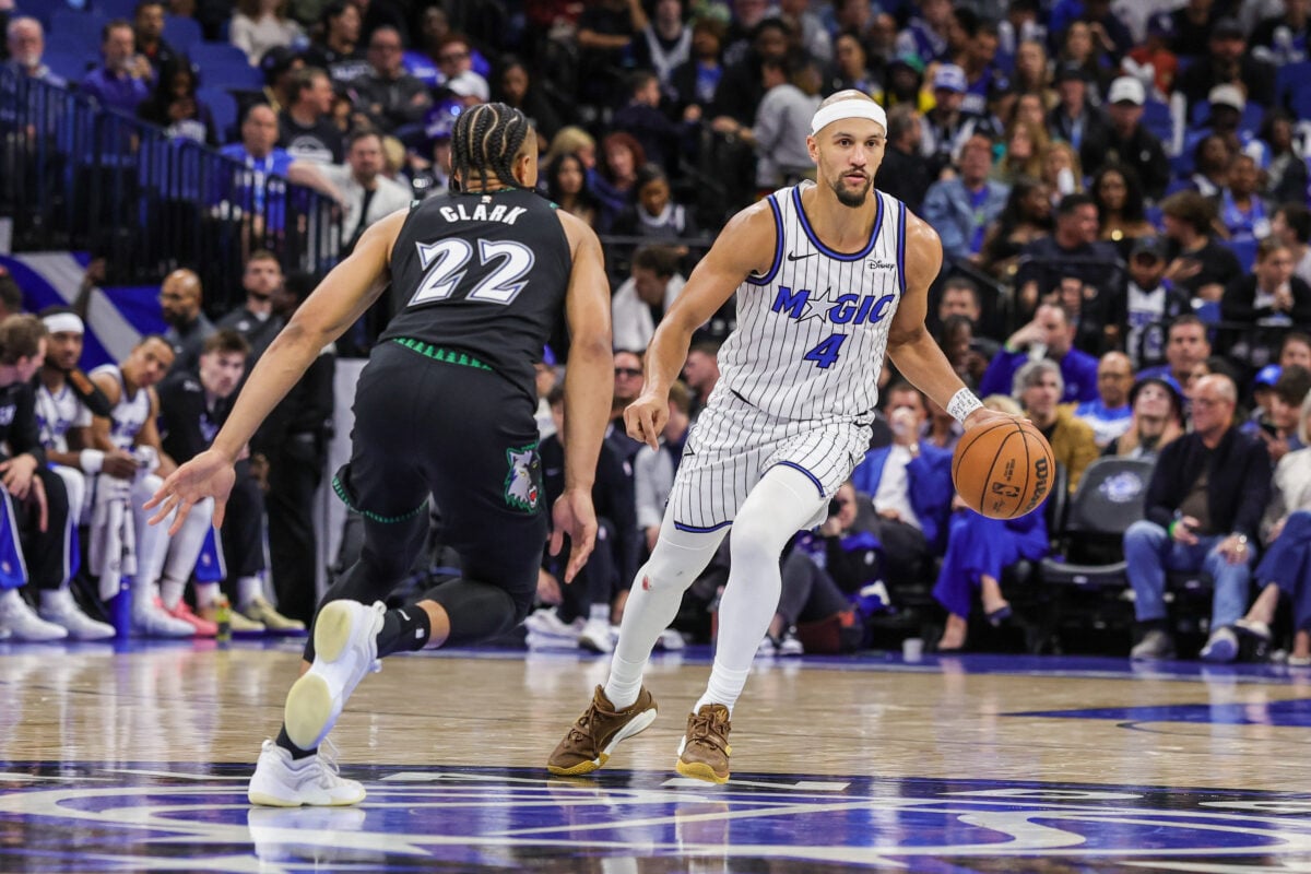 Apr 8, 2026; Orlando, Florida, USA; Orlando Magic guard Jalen Suggs (4) brings the ball up court against Minnesota Timberwolves guard Jaylen Clark (22) during the second half at Kia Center. Mandatory Credit: Mike Watters-Imagn Images