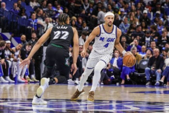 Apr 8, 2026; Orlando, Florida, USA; Orlando Magic guard Jalen Suggs (4) brings the ball up court against Minnesota Timberwolves guard Jaylen Clark (22) during the second half at Kia Center. Mandatory Credit: Mike Watters-Imagn Images