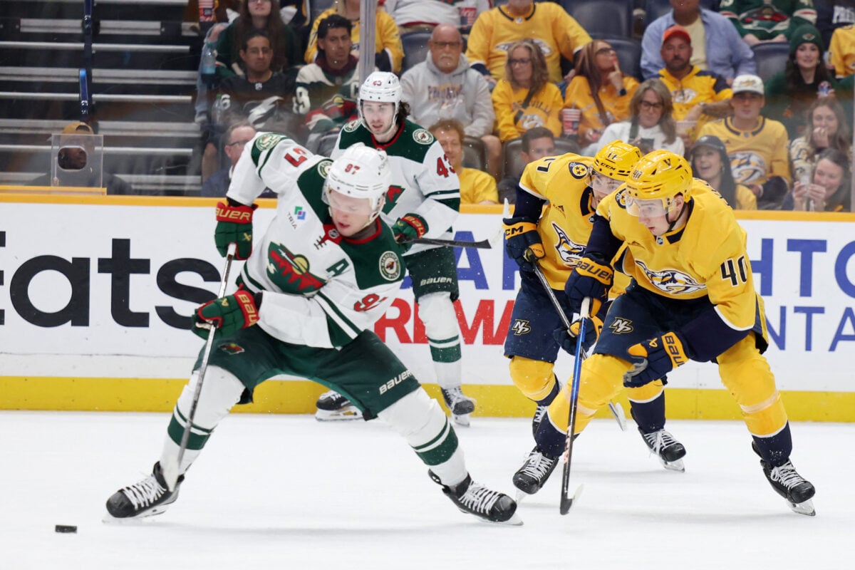 Apr 11, 2026; Nashville, Tennessee, USA; Minnesota Wild left wing Kirill Kaprizov (97) attacks as Nashville Predators center Fedor Svechkov (40) defends during the second period of their game at Bridgestone Arena. Mandatory Credit: Alan Poizner-Imagn Images