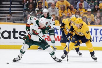 Apr 11, 2026; Nashville, Tennessee, USA; Minnesota Wild left wing Kirill Kaprizov (97) attacks as Nashville Predators center Fedor Svechkov (40) defends during the second period of their game at Bridgestone Arena. Mandatory Credit: Alan Poizner-Imagn Images