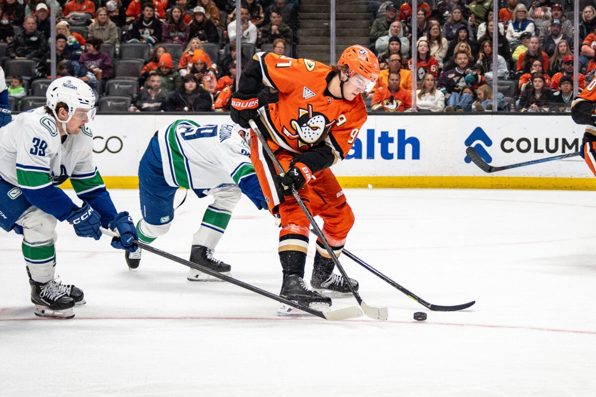 Apr 12, 2026; Anaheim, California, USA; Anaheim Ducks center Leo Carlsson (91) skates with the puck against Vancouver Canucks center Ty Mueller (39) during the second period at Honda Center. Mandatory Credit: Corinne Votaw-Imagn Images
