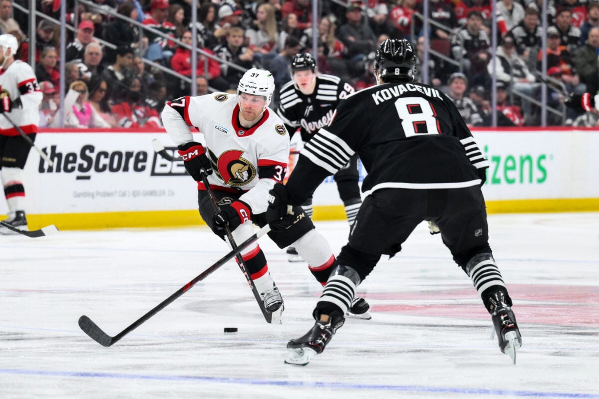 Apr 12, 2026; Newark, New Jersey, USA; Ottawa Senators left wing Warren Foegele (37) skates against New Jersey Devils defenseman Johnathan Kovacevic (8) during the third period at Prudential Center. Mandatory Credit: John Jones-Imagn Images
