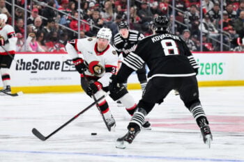 Apr 12, 2026; Newark, New Jersey, USA; Ottawa Senators left wing Warren Foegele (37) skates against New Jersey Devils defenseman Johnathan Kovacevic (8) during the third period at Prudential Center. Mandatory Credit: John Jones-Imagn Images