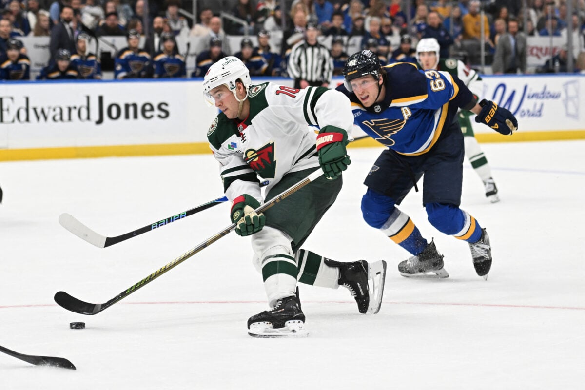 Apr 13, 2026; St. Louis, Missouri, USA; St. Louis Blues left wing Jake Neighbours (63) pressures Minnesota Wild right wing Bobby Brink (10) in the third period at Enterprise Center. Mandatory Credit: Joe Puetz-Imagn Images