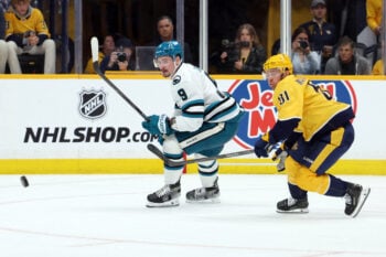 Apr 13, 2026; Nashville, Tennessee, USA; San Jose Sharks defenseman Dmitry Orlov (9) competes for the puck with Nashville Predators center Jonathan Marchessault (81) during the second period of their game at Bridgestone Arena. Mandatory Credit: Alan Poizner-Imagn Images