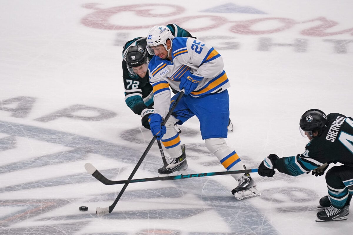 Mar 30, 2026; San Jose, California, USA; St. Louis Blues right winger Jordan Kyrou (25) controls the puck between San Jose Sharks left wing William Eklund (72) and left wing Kiefer Sherwood (44) in the third period at SAP Center at San Jose. Mandatory Credit: David Gonzales-Imagn Images