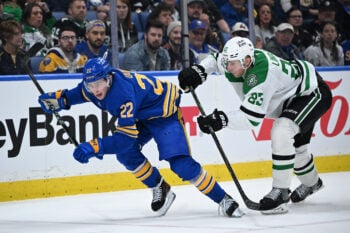 Apr 15, 2026; Buffalo, New York, USA; Buffalo Sabres right wing Jack Quinn (22) is pushed by Dallas Stars defenseman Esa Lindell (23) in the second period at KeyBank Center. Mandatory Credit: Mark Konezny-Imagn Images