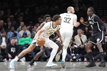 Apr 9, 2026; Brooklyn, New York, USA; Indiana Pacers forward Jalen Slawson (18) dribbles the ball against Brooklyn Nets guard Drake Powell (4) during the first half at Barclays Center. Mandatory Credit: Gregory Fisher-Imagn Images