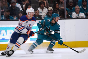 Apr 8, 2026; San Jose, California, USA;  Edmonton Oilers defenseman Ty Emberson (49) is defended by San Jose Sharks left wing William Eklund (72) in the second period at SAP Center at San Jose. Mandatory Credit: David Gonzales-Imagn Images