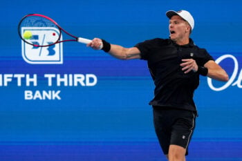 Aug 14, 2026; Mason, OH, USA;  Jenson Brooksby (USA) returns a shot against Jamie Faria (POR) during the Cincinnati Open at Lindner Family Tennis Center. Mandatory Credit: Aaron Doster-Imagn Images