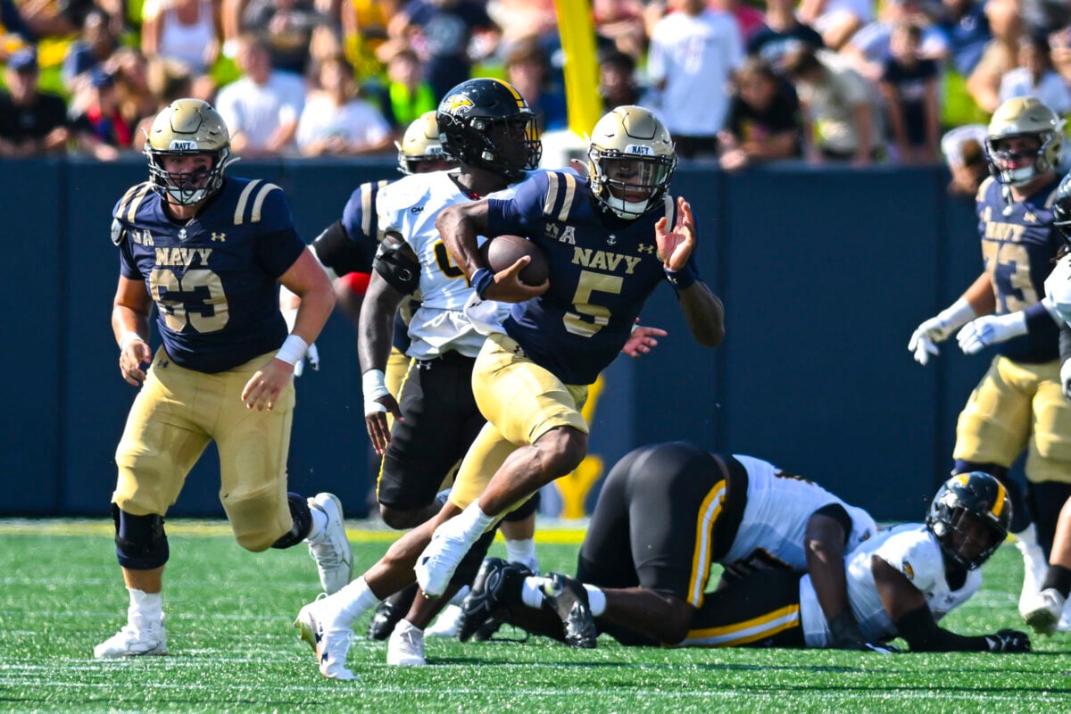 Sep 5, 2026; Annapolis, Maryland, USA; Navy Midshipmen quarterback Braxton Woodson (5) rushes during the first half Towson Tigers at Navy-Marine Corps Memorial Stadium. Mandatory Credit: Tommy Gilligan-Imagn Images