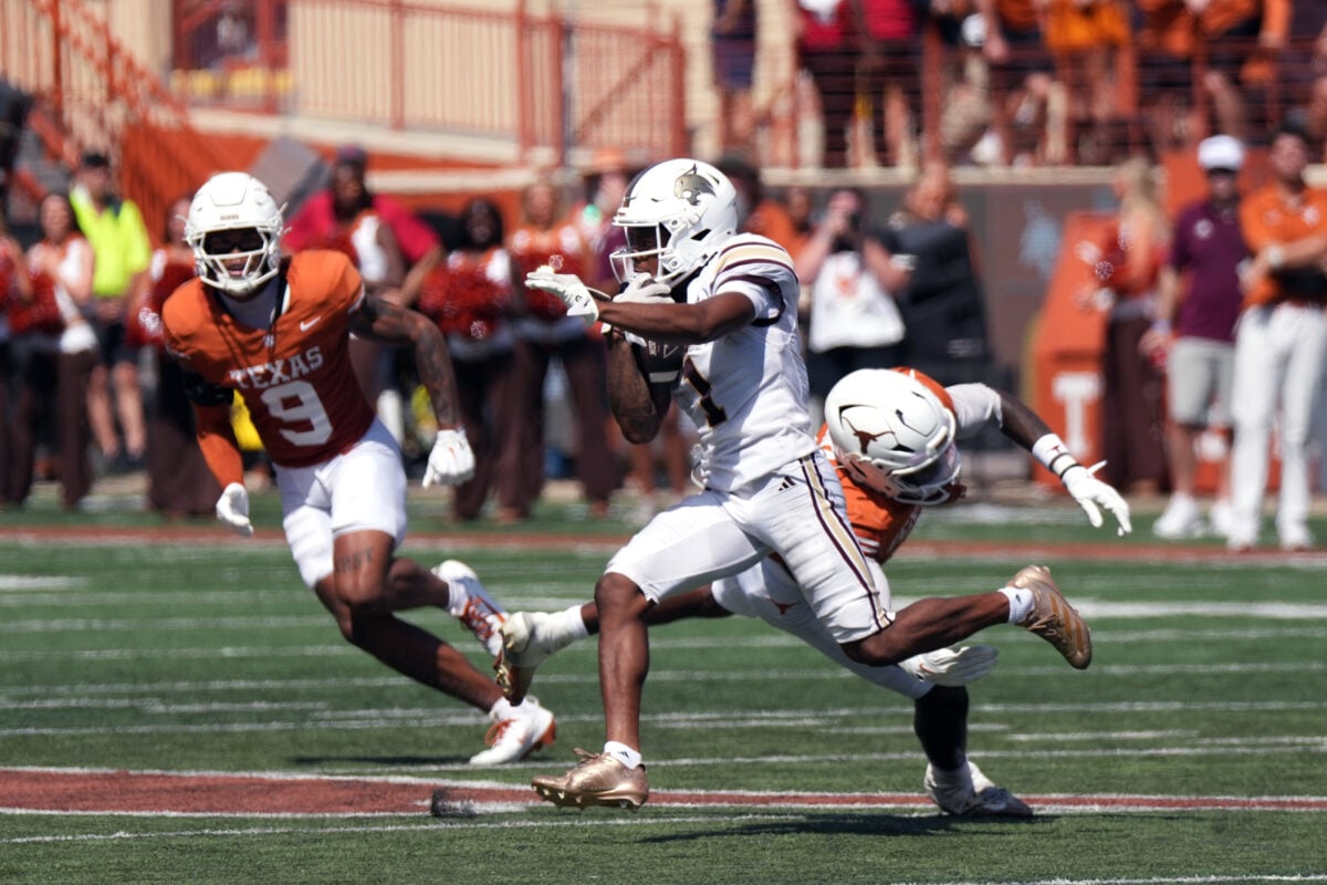 Sep 5, 2026; Austin, Texas, USA;  Texas State Bobcats   wide receiver Chris Dawn, Jr. (1) escapes a tackle attempt by Texas Longhorns defensive back Jonah Williams (9) during the second quarter at Darrell K Royal-Texas Memorial Stadium.  Mandatory Credit: Scott Wachter-Imagn Images