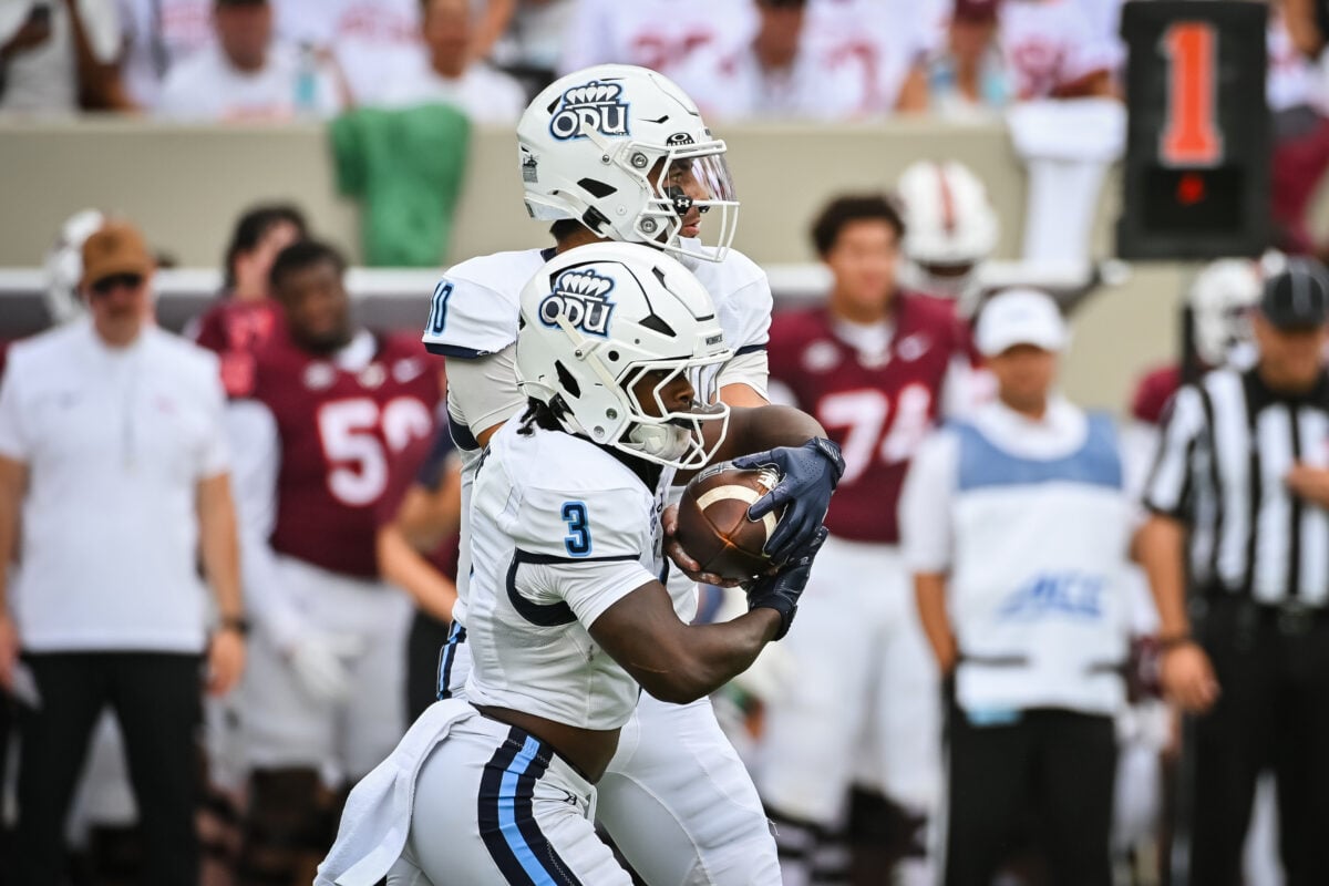 Sep 12, 2026; Blacksburg, Virginia, USA;  Old Dominion Monarchs quarterback Quinn Henicle (10) hands the ball off to running back Devin Roche (3) during the first quarter at Lane Stadium.  Mandatory Credit: Brian Bishop-Imagn Images