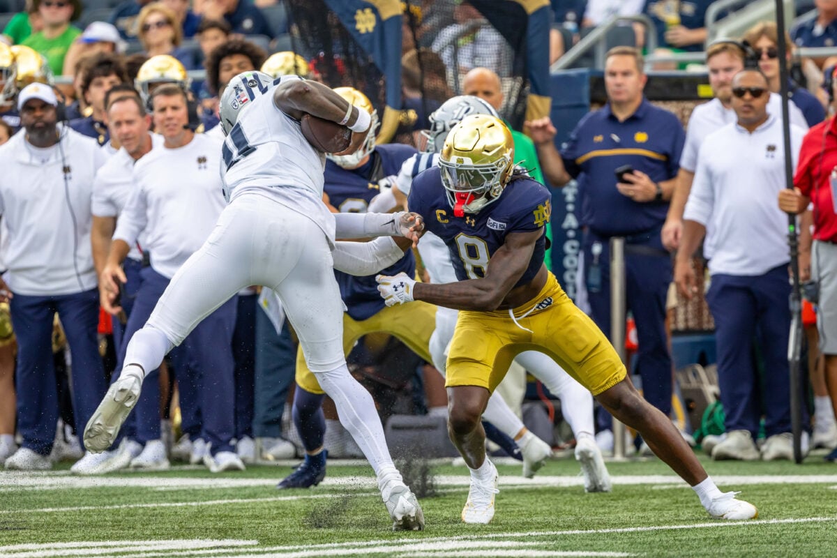 Sep 12, 2026; South Bend, Indiana, USA; Notre Dame Fighting Irish safety Adon Shuler (8) tries to tackle Rice Owls quarterback Jacurri Brown (11) during the first half against the Rice Owls at Notre Dame Stadium. Mandatory Credit: Michael Caterina-Imagn Images