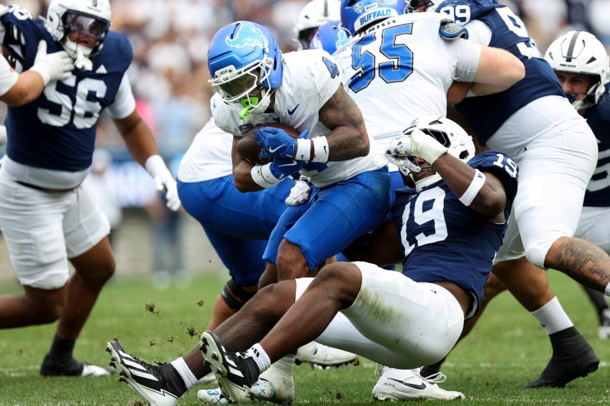 Sep 19, 2026; University Park, Pennsylvania, USA; Buffalo Bulls running back Messiah Burch (4) runs with he ball before being tackled by Penn State Nittany Lions defensive end Yvan Kemajou (19) during the second quarter of the game at West Shore Home Field at Beaver Stadium. Mandatory Credit: Matthew O'Haren-Imagn Images