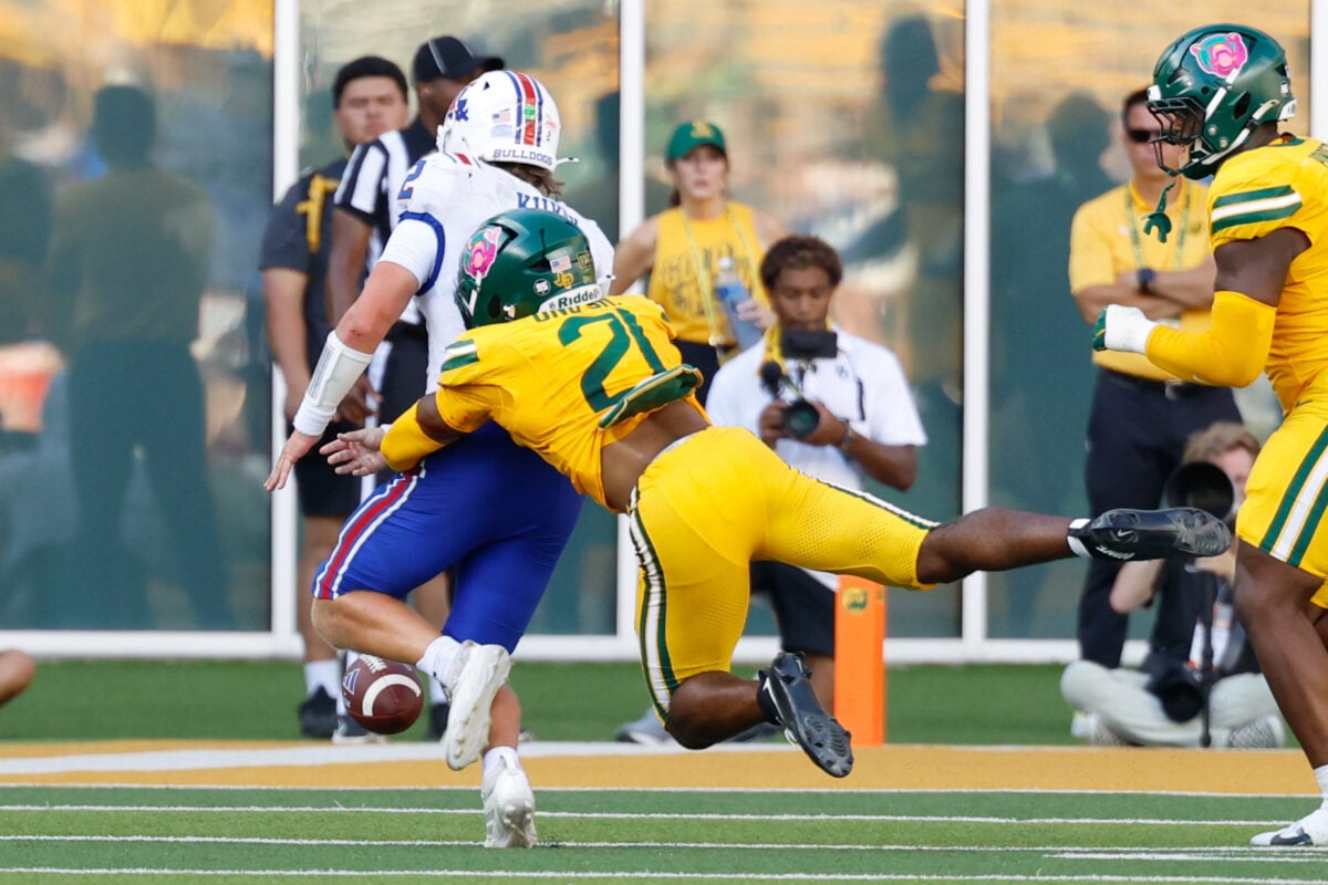 Sep 19, 2026; Waco, Texas, USA; Louisiana Tech Bulldogs quarterback Trey Kukuk (2) fumbles the ball as he is tackled by Baylor Bears safety Bo Onu (21) during the second half at McLane Stadium. Mandatory Credit: Chris Jones-Imagn Images