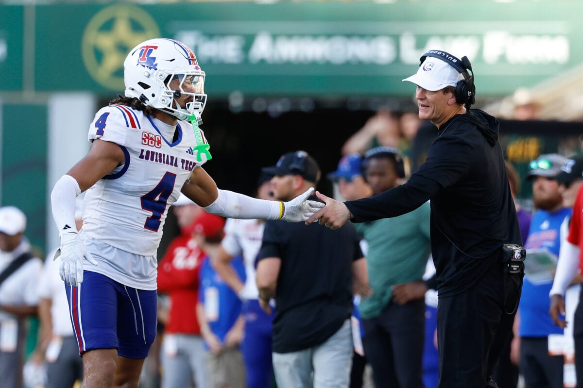 Sep 19, 2026; Waco, Texas, USA;  Louisiana Tech Bulldogs head coach Sonny Cumbie reacts with Louisiana Tech Bulldogs defensive back Kam Franklin (4) during the second half against the Baylor Bears at McLane Stadium.  Mandatory Credit: Chris Jones-Imagn Images