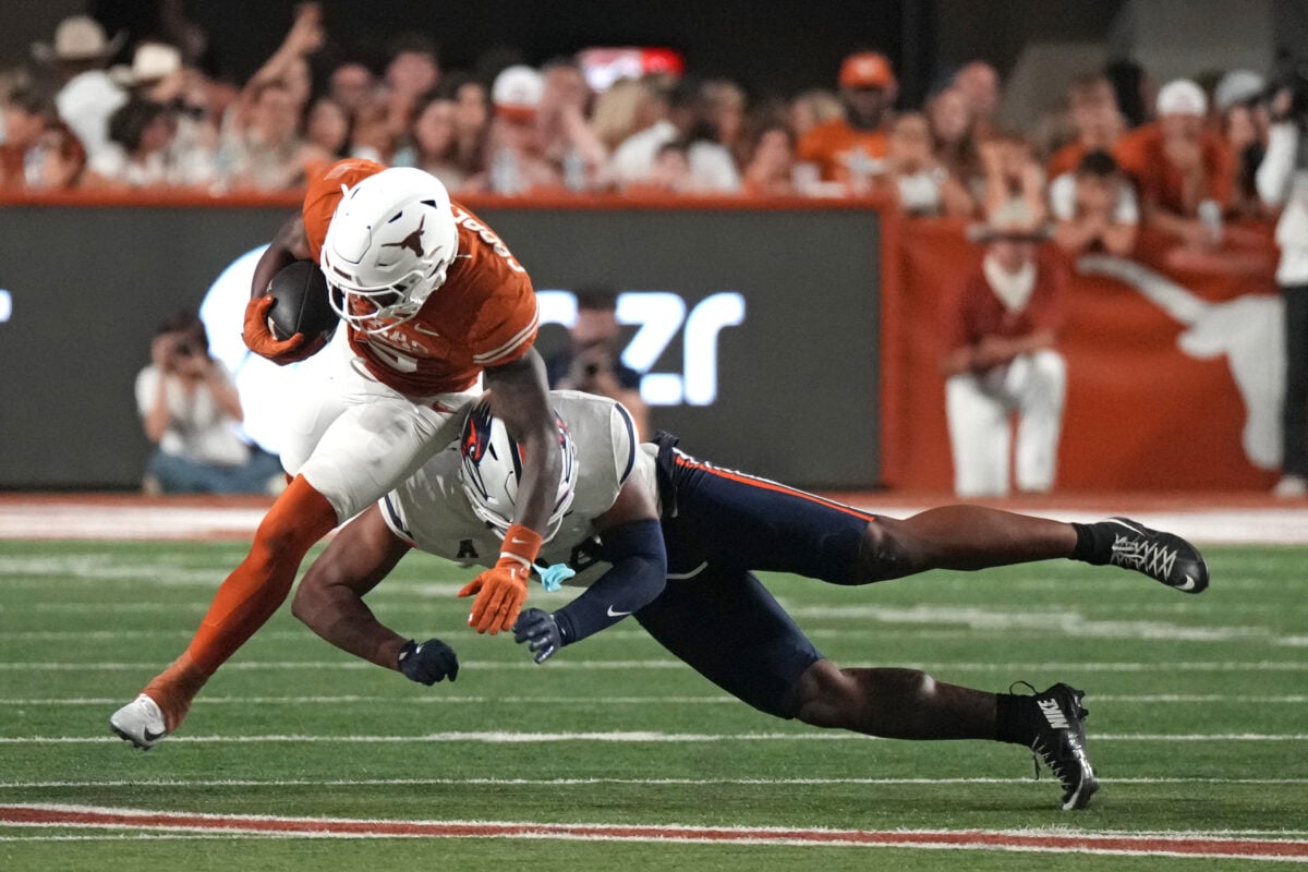 Sep 19, 2026; Austin, Texas, USA; Texas Longhorns running back Derrek Cooper (5) runs for yardage while defended by UTSA Roadrunners linebacker James Walley Jr. (34) during the second half at Darrell K Royal-Texas Memorial Stadium. Mandatory Credit: Scott Wachter-Imagn Images